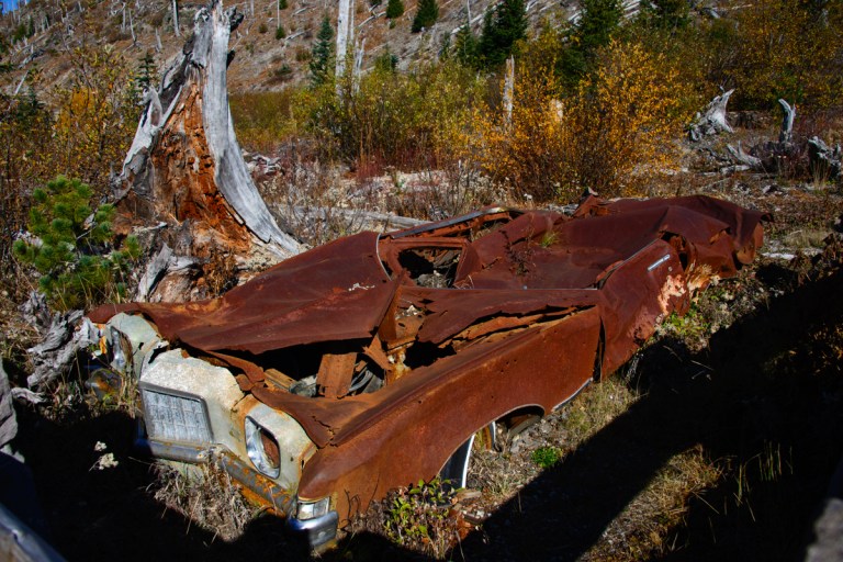 This is known as the Miner's Car. It was a 1972 green Pontiac Grand Prix. The family hiked and later died in a miner's cabin nearby. This car was supposedly in the safer "Blue Zone" which was open to those conducting business under a permit if they signed a liability waiver with the state. The car remained after the blast.
